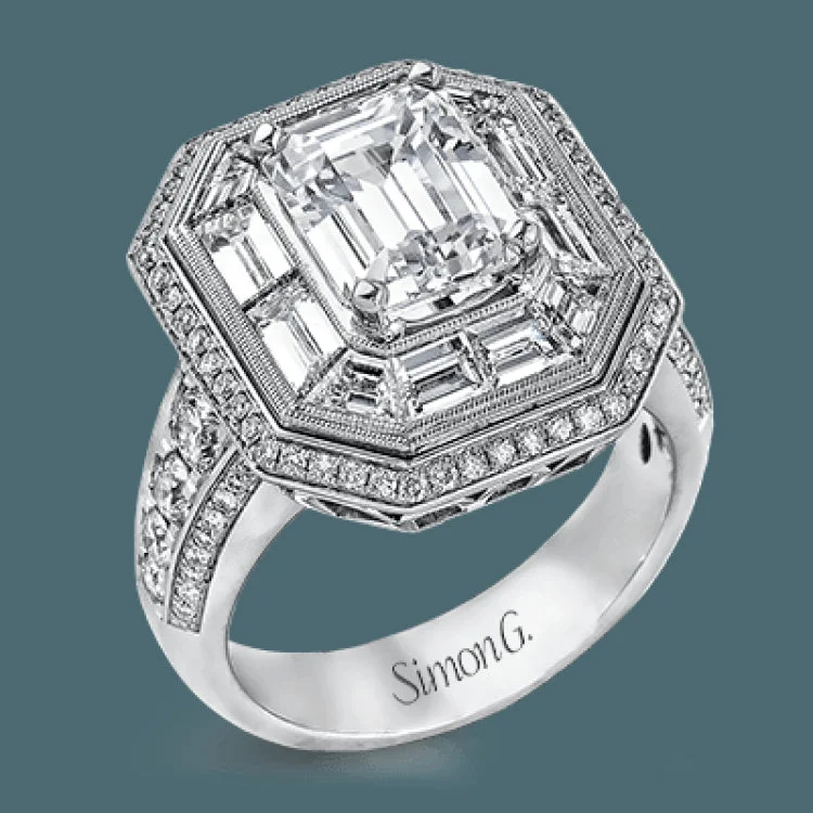 Women’s engraved engagement ring-This gorgeous white gold contemporary engagement features an arresting 1.65 ctw of mosaic diamonds accentuated by .80 ctw of princess cut white diamonds.