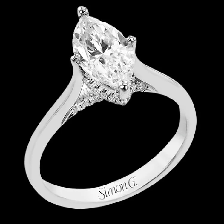 Women’s custom gold engagement ring-This elegant white gold engagement ring takes an marquise center and is adorned with a delicate under halo, and a line of diamonds on the side profile 0.13 ctw