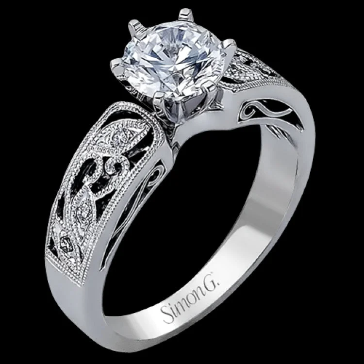 Women’s simple engagement ring-This intricately designed white gold engagement ring features .07 ctw of exquisite round cut white diamonds, setting the stage for a stunning center stone.