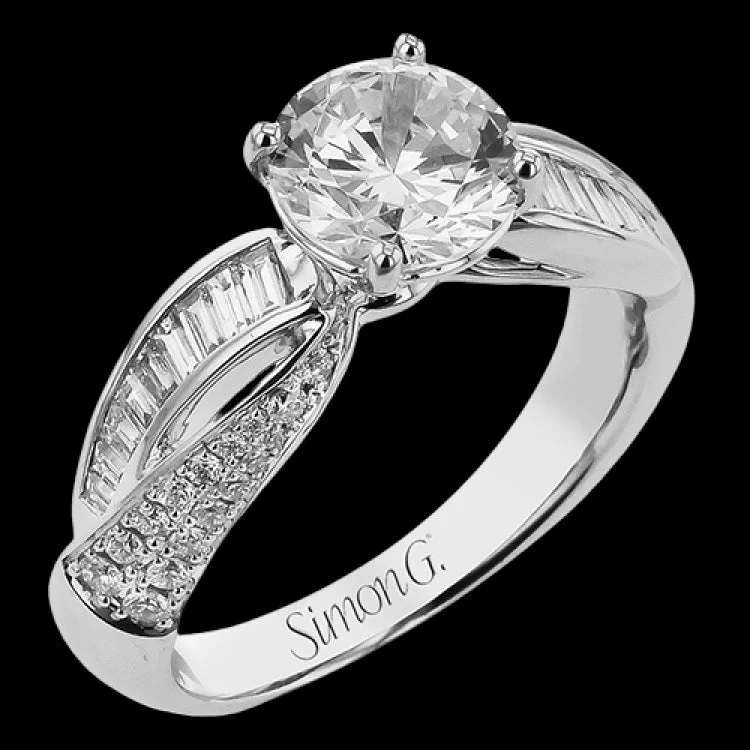 Women’s gold engagement ring-This split shank twist engagement ring takes a round center, and has a line of tapered baguettes 0.34 ctw., accented with .21 ctw RD pave diamonds