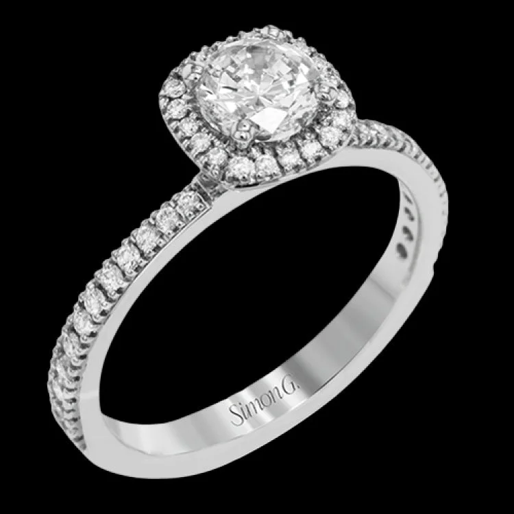 Women’s classic engagement ring-Accented by .46 ctw of glistening round cut white diamonds, this contemporary white gold halo style engagement ring and wedding band set makes a dramatic statement.