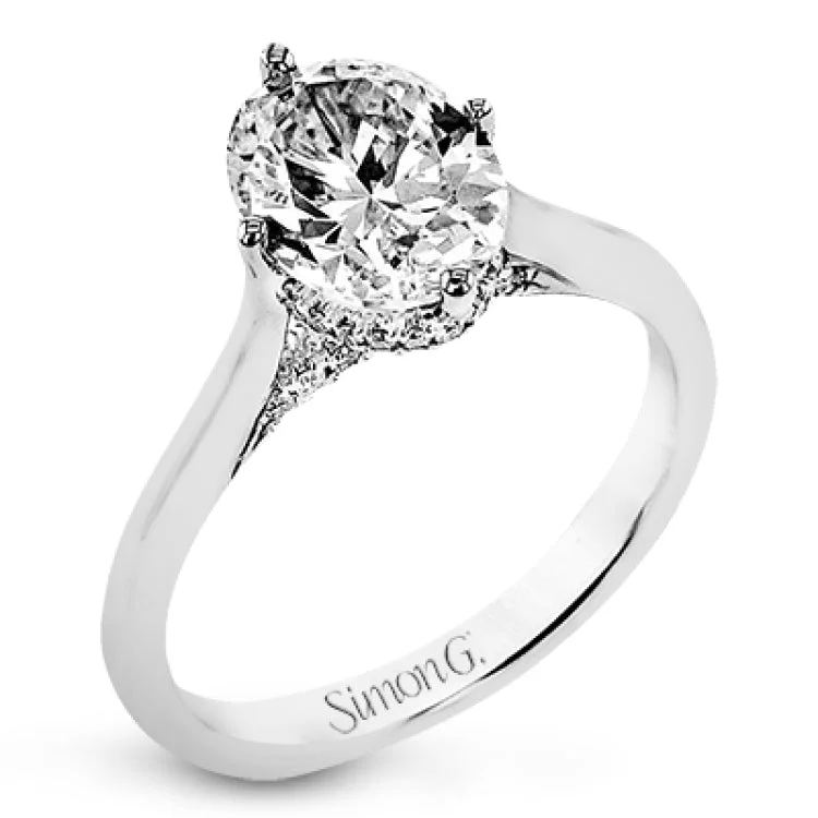 Women’s engagement ring with platinum band-This elegant white gold engagement ring takes an oval center and is adorned with a delicate under halo, and a line of diamonds on the side profile 0.13 ctw