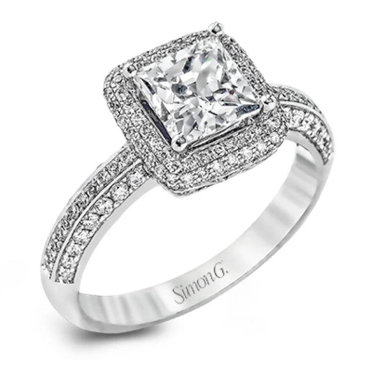 Women’s round diamond engagement ring-This vintage-inspired 18k white gold engagement ring is the perfect design for princess cut center stone because it has a detailed square shaped halo. The entire ring is set with .62 ctw of white diamonds.